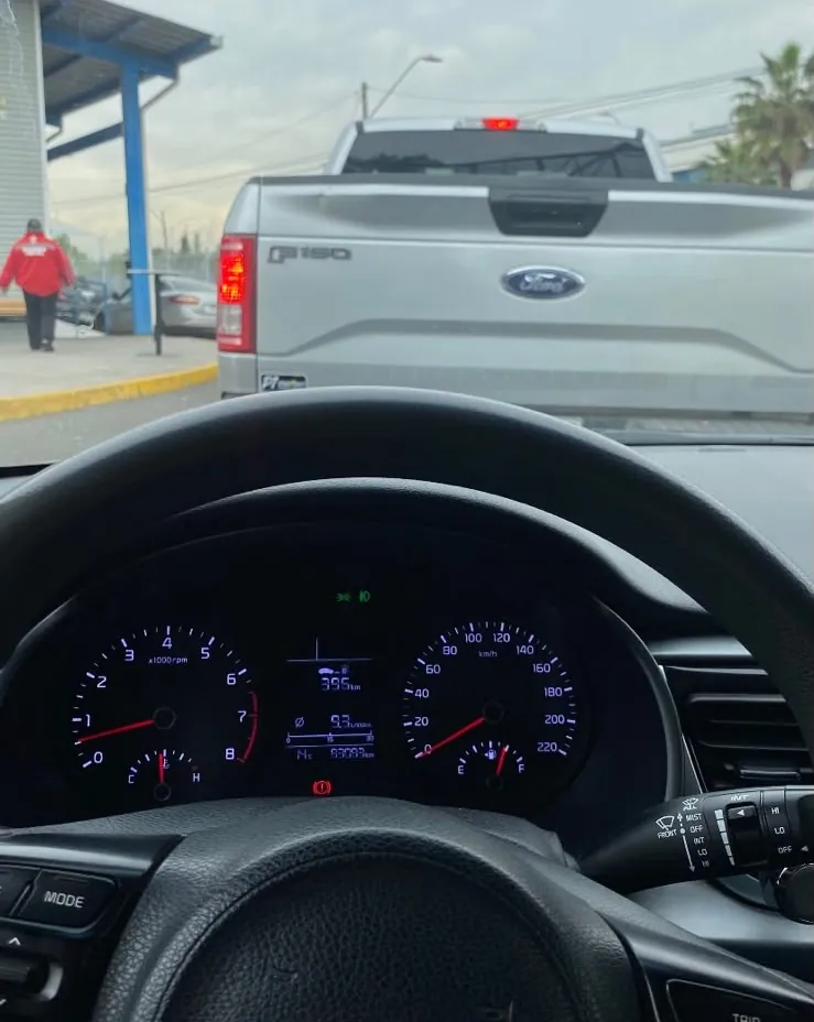 Vista desde un Kia durante una revisión técnica: delante, una Ford F-150 en la fila